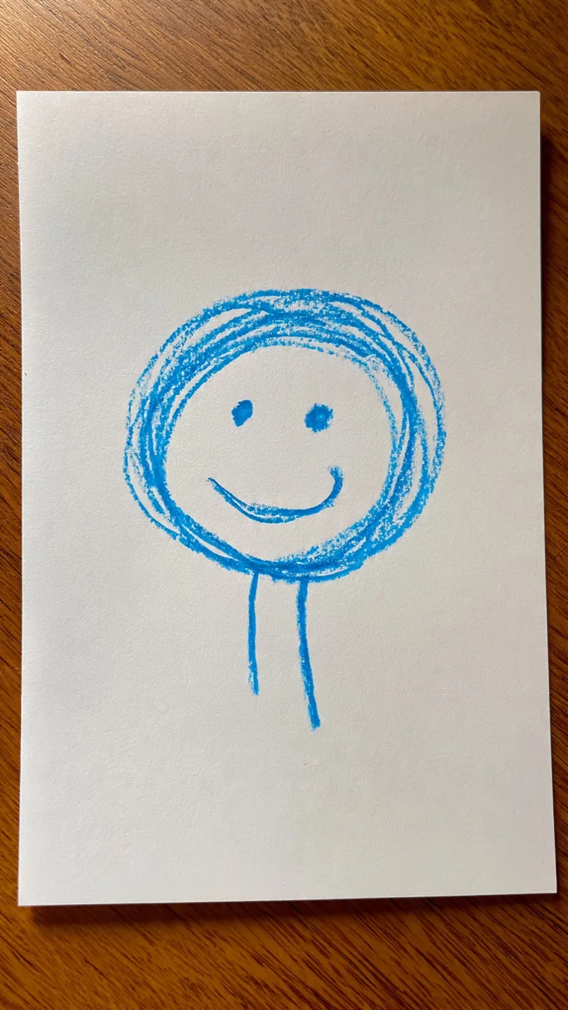 A young child's blue crayon drawing of a person as a circle face with two dot eyes, a smile, and two legs hanging from the base — no body
