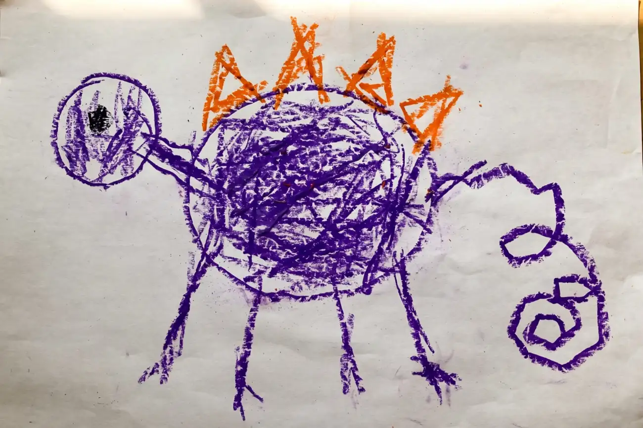 A child's crayon drawing on white paper of a four-legged purple creature with a round scribbled body, orange triangle spikes along its back, one dot eye and a long curling tail