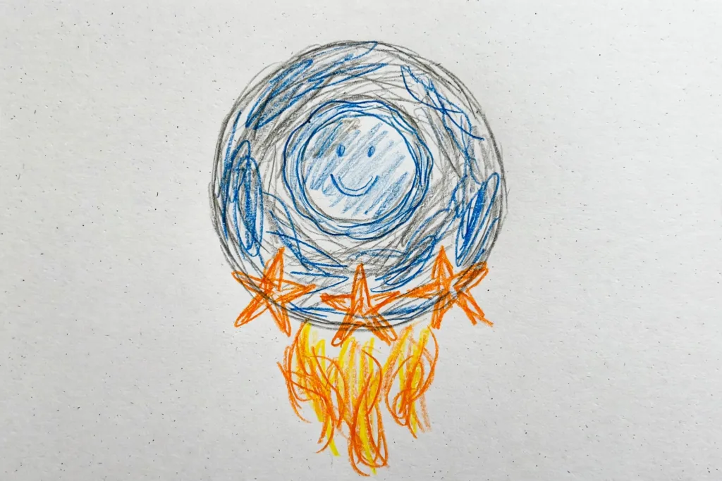 Benji's colored pencil drawing of a round smiling spaceship with orange star fins, used as the hero of his Hanukkah DoodleTale storybook