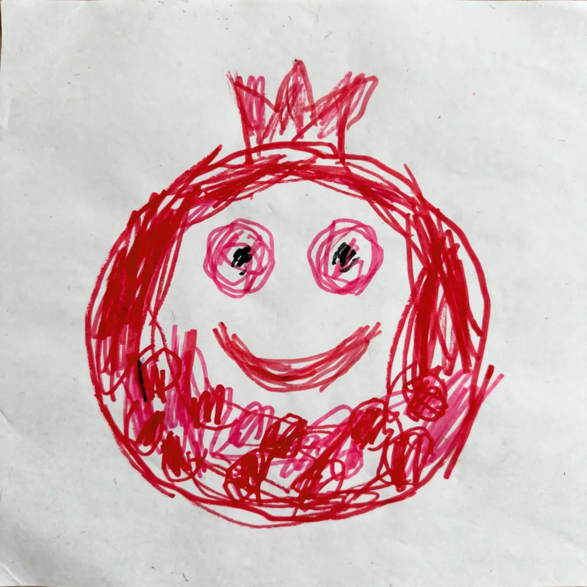 Shira's marker drawing of a smiling pomegranate, turned into the hero of her Rosh Hashanah DoodleTale storybook