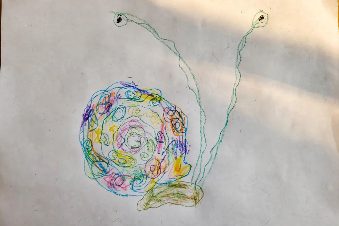 Beckett's colored pencil drawing of a snail with an enormous spiral shell and two very long wobbly eye stalks, used as the hero of his bedtime DoodleTale storybook