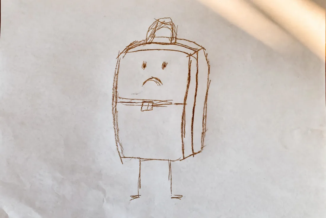 Osei's colored pencil drawing of a brown suitcase with two thin legs, a handle on top and a worried mouth, used as the hero of his DoodleTale storybook